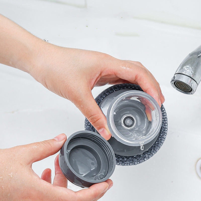 Person holding two scrubber heads over a sink