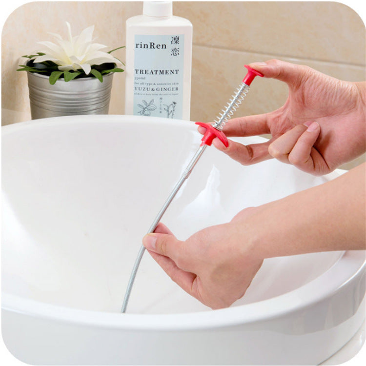 Person using a cleaning tool over a sink with a bottle labeled 'rinRen' in the background.