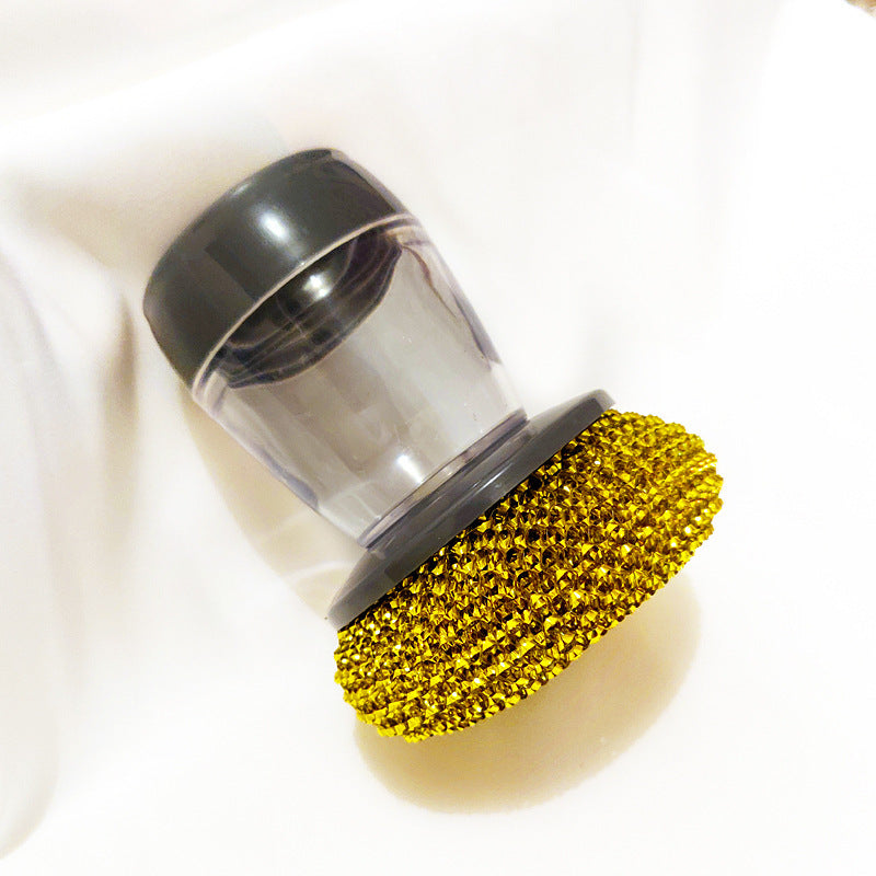 Cleaning brush with gold bristle head on a white background