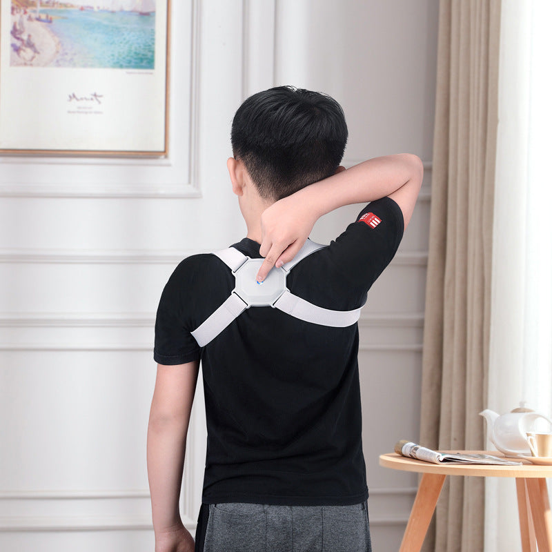 Person wearing a black shirt with a white shoulder brace indoors.