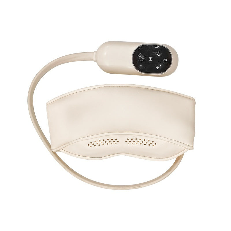 A person is lying down wearing a white eye mask with a massage device placed on their head. The device appears to be portable and designed for stress relief and massage.