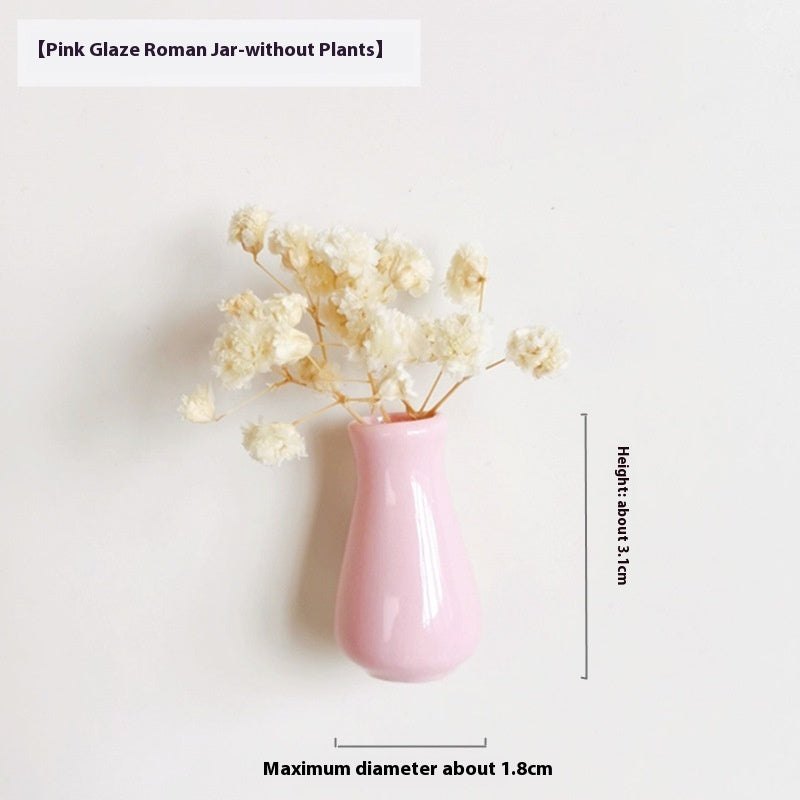 Pink glaze Roman jar with dried flowers on a white background