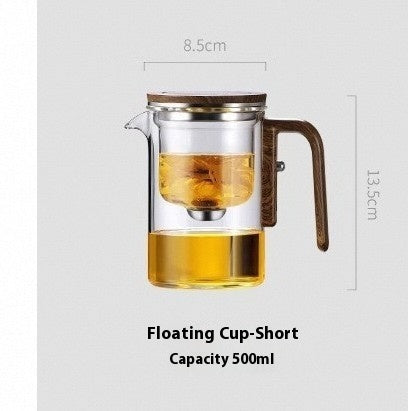 Glass teapot with wooden handle and measurement details on a light gray background