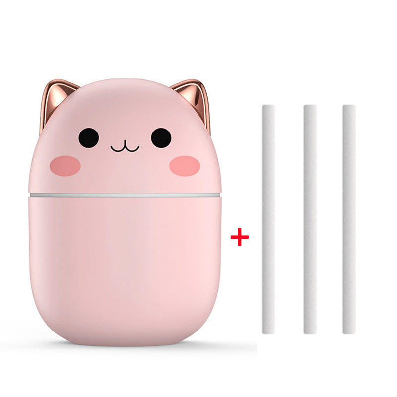 Pink cat-shaped humidifier with two white sticks on a white background