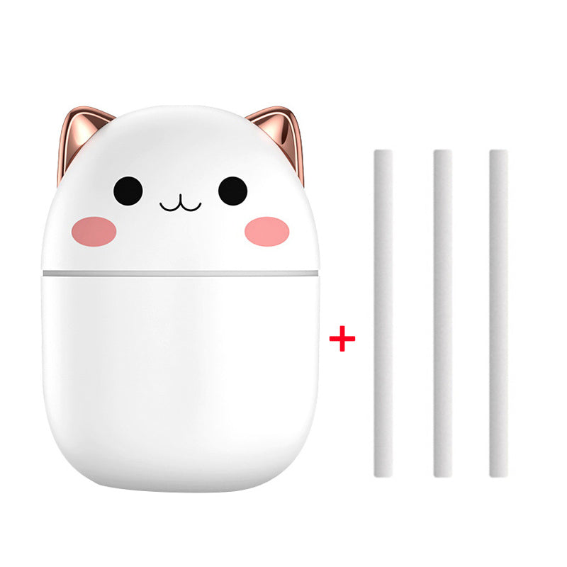 Cute white cat-shaped device with rose gold accents and three white sticks on a white background