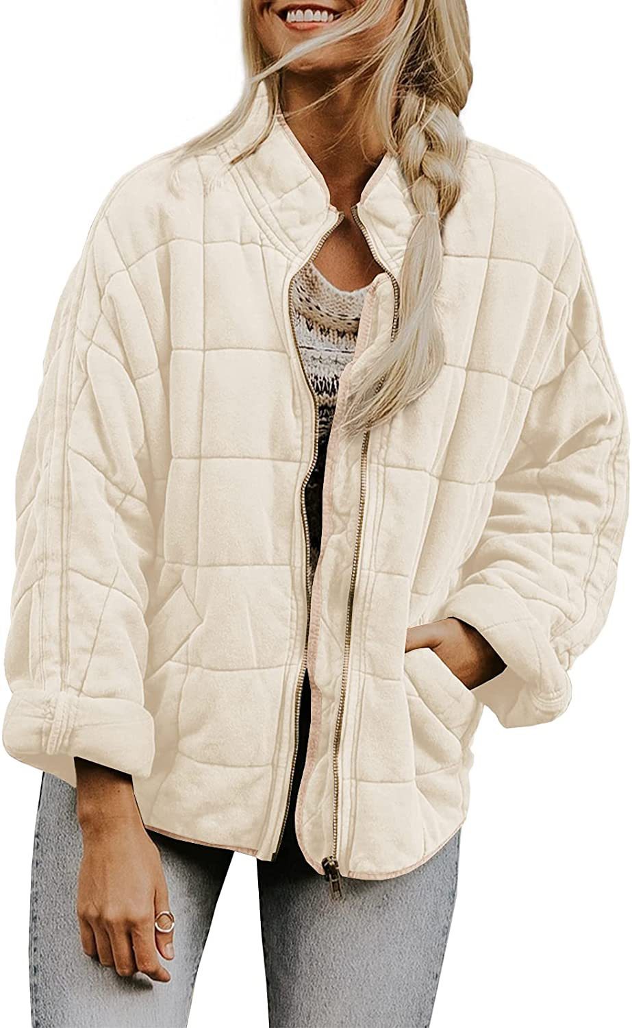 Woman wearing a beige quilted jacket on a white background