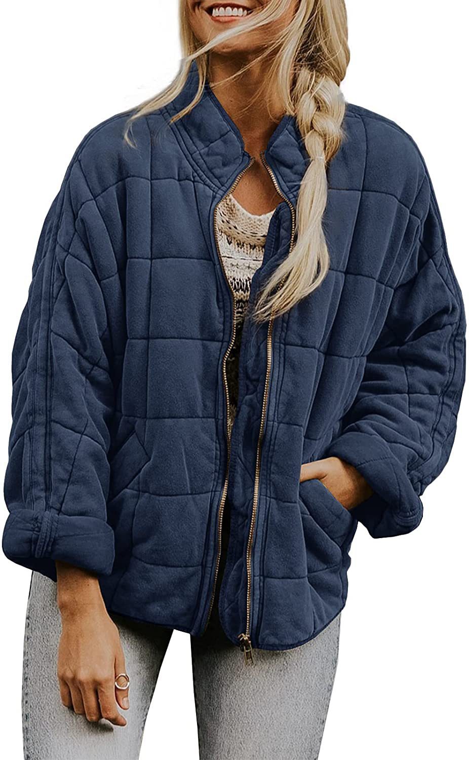 Woman wearing a blue quilted jacket on a white background
