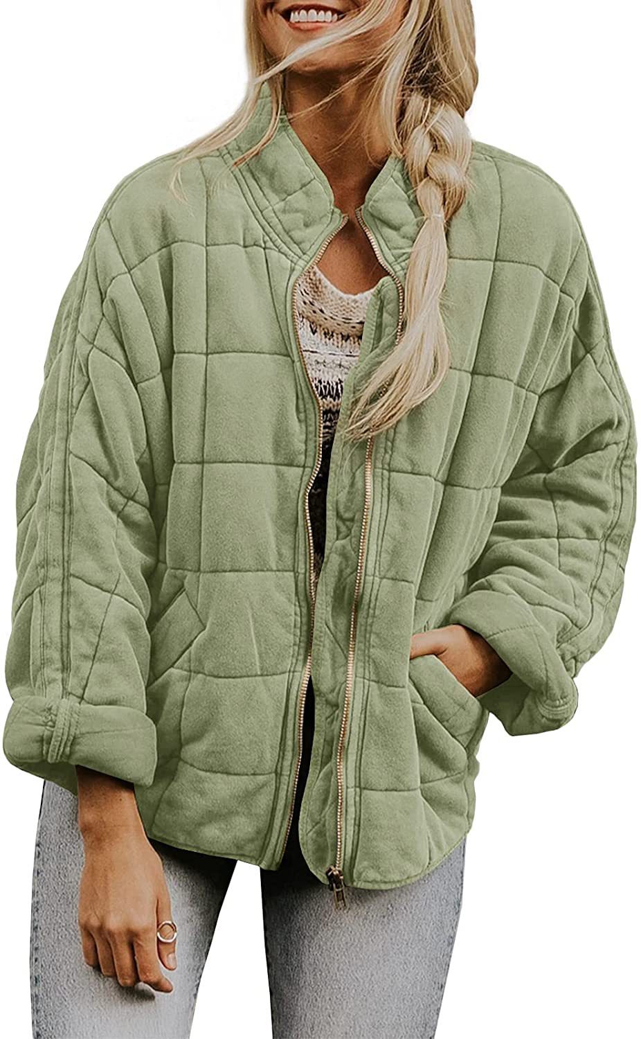 Woman wearing a green quilted jacket on a white background