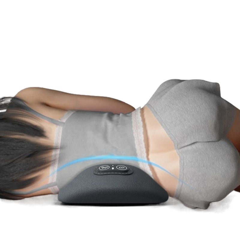 Person using a gray massage pillow with digital display on a white background
