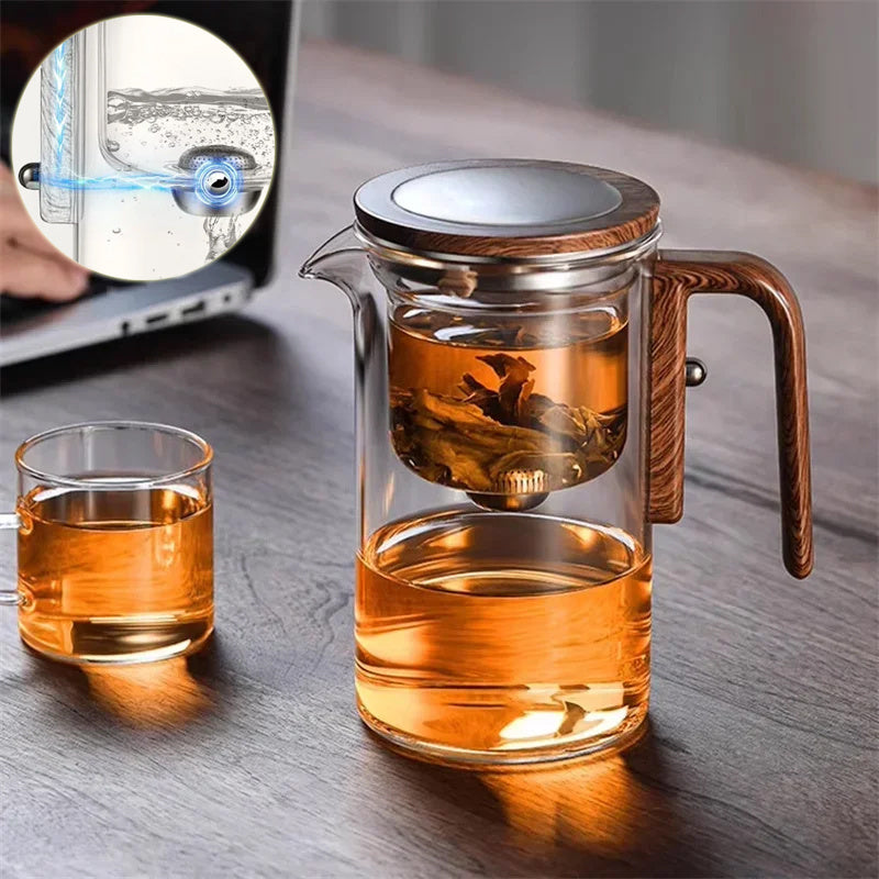 Glass teapot with wooden handle and glass cup on a wooden surface, with a close-up inset showing a laptop screen.