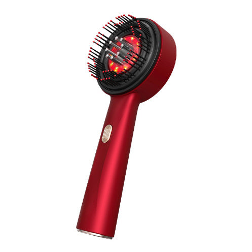 A person is holding a red electric massage comb with a black head, demonstrating its design and size.