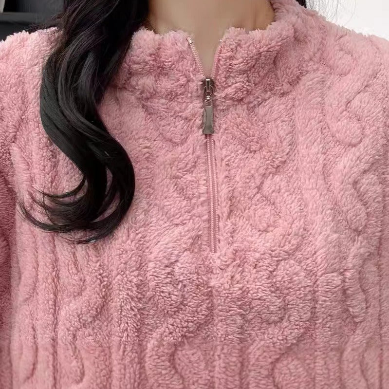 Close-up of a pink fleece pullover with a zipper