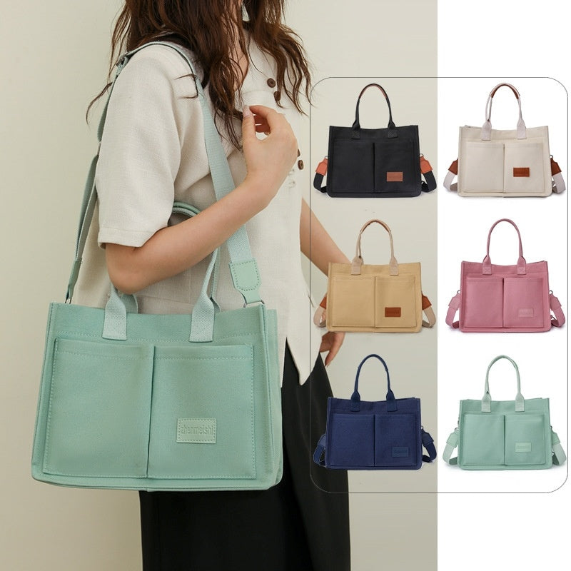 A collection of canvas tote shoulder bags in various colors, displayed in multiple pockets and with adjustable shoulder straps, showcased in a vertical format.