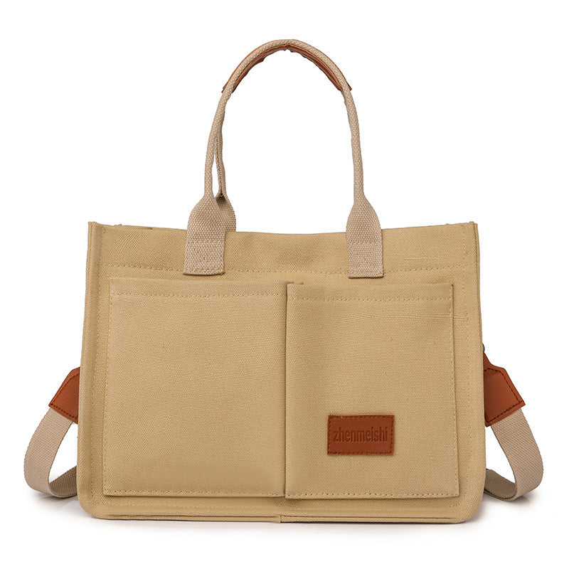 Beige tote bag with brown accents on a white background
