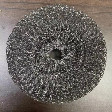 Metal scrubber on a wooden surface