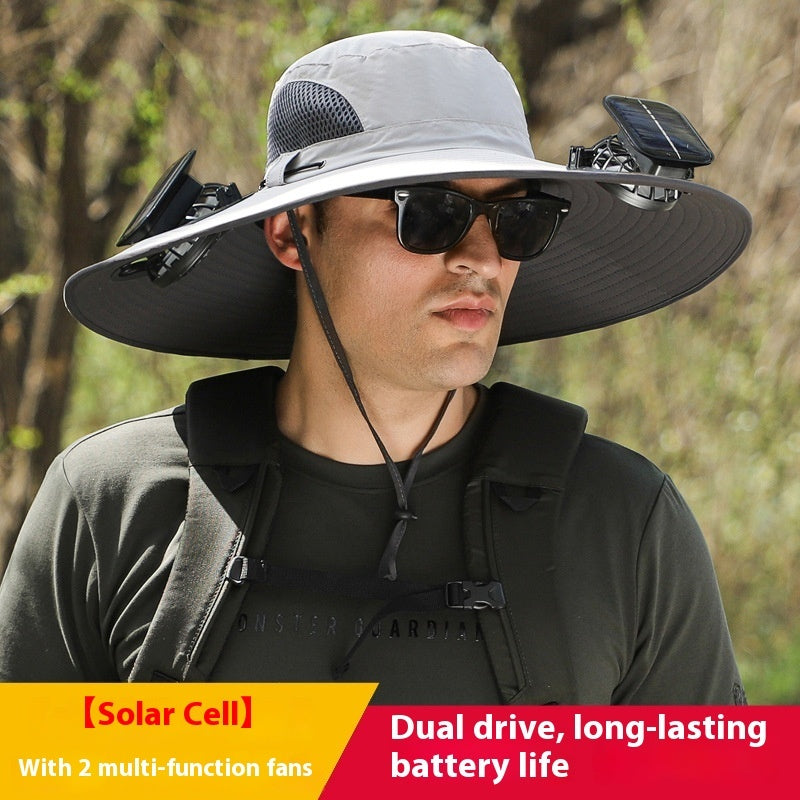 Person wearing a hat with solar cell and fans, set against a natural background