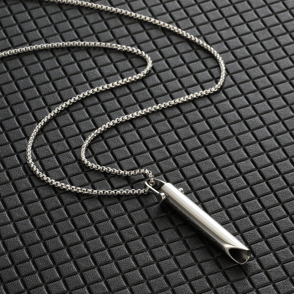 Silver pendant necklace on a textured black surface