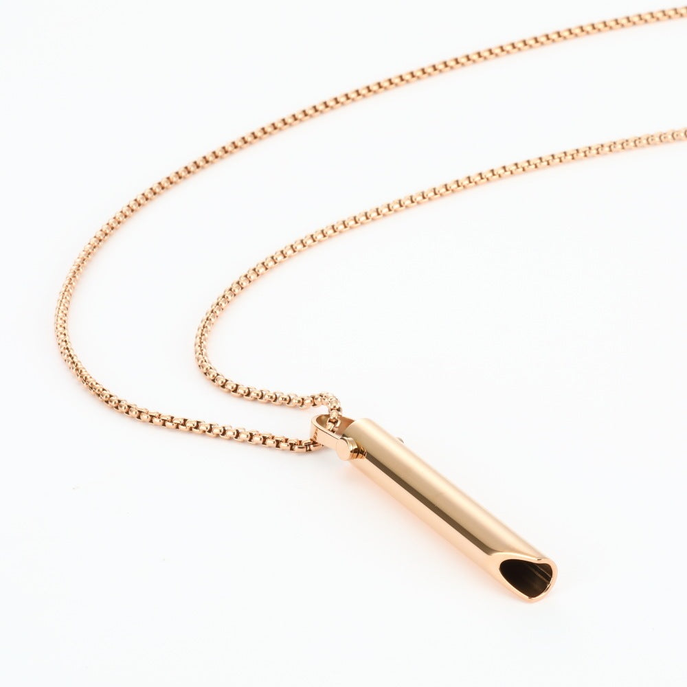 Rose gold necklace with a cylindrical pendant on a white background