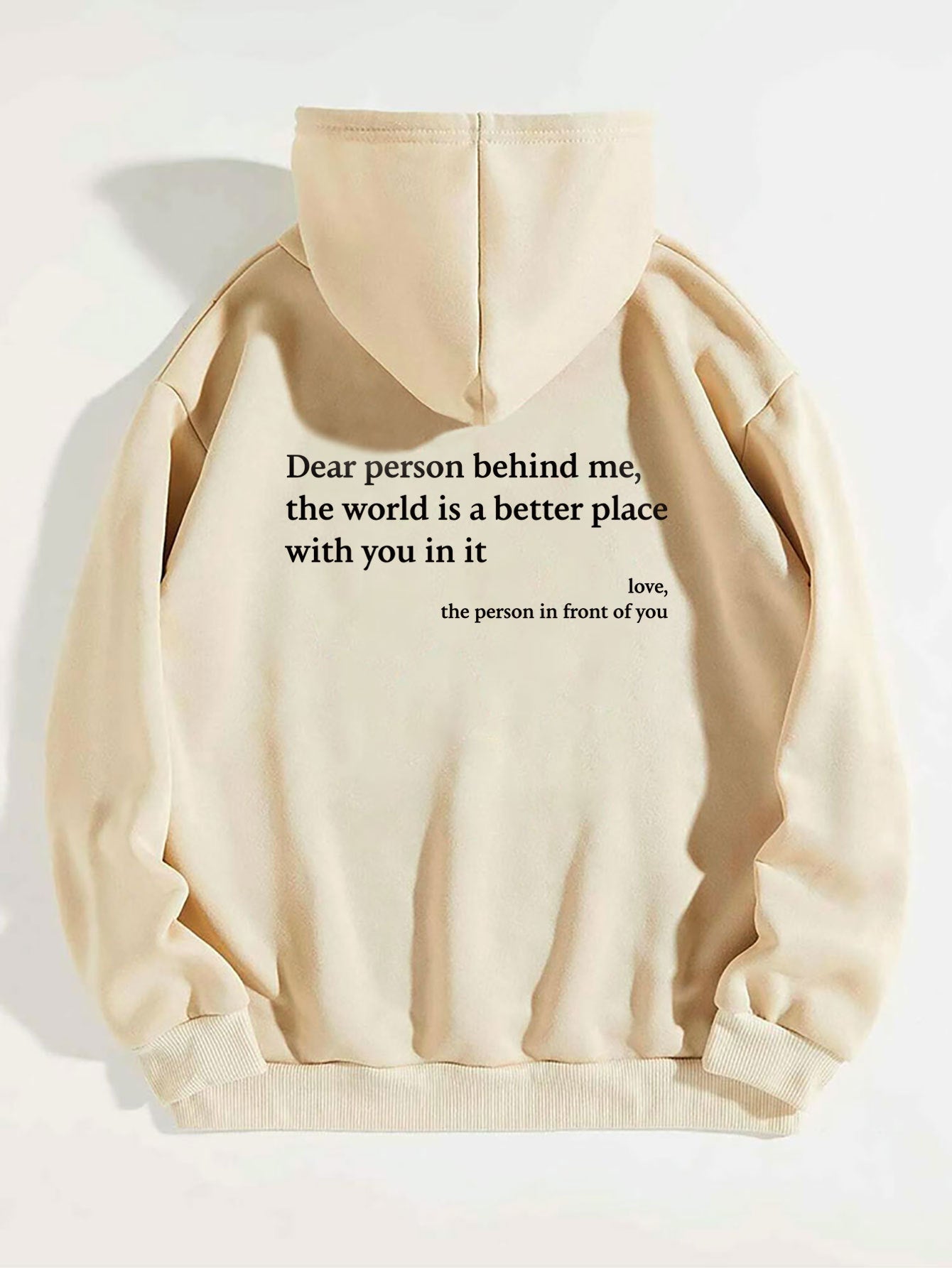 Beige hoodie with a motivational quote on a white background