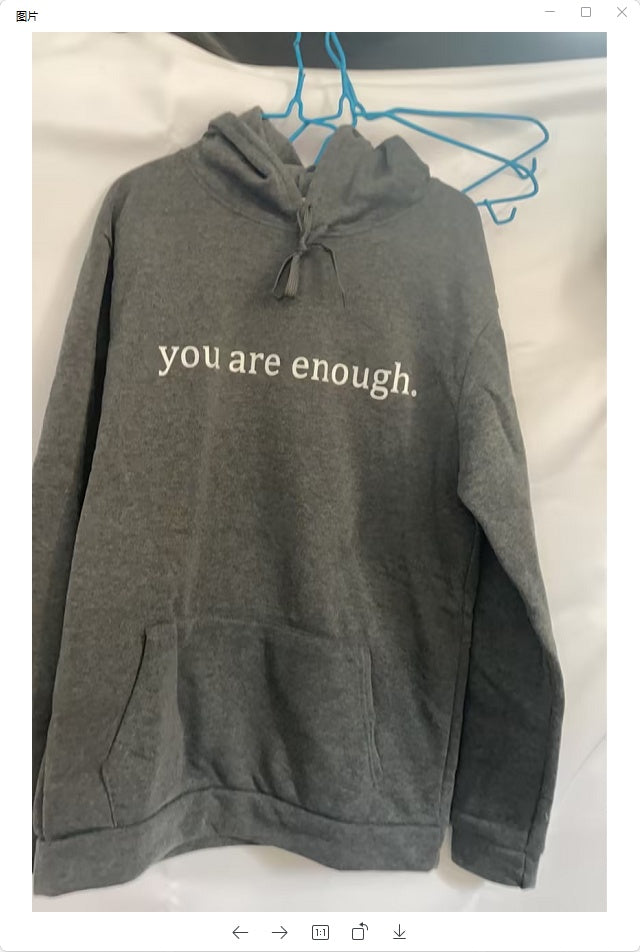 Gray hoodie with 'you are enough' text on a white background