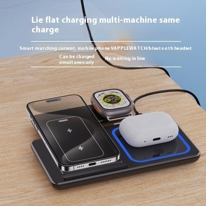 Wireless charging pad with smartphone, smartwatch, and wireless earbuds on a wooden surface.