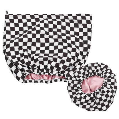 Black and white checkered shower cap with pink interior on a white background