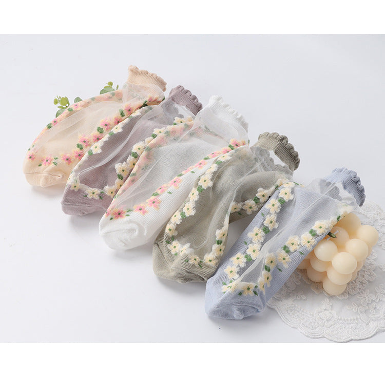 Set of floral-patterned sheer socks on a light background