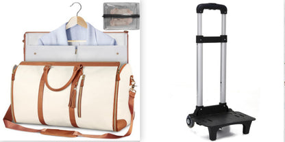White duffel bag with brown leather straps, hanger with shirt, and black hand truck on white background