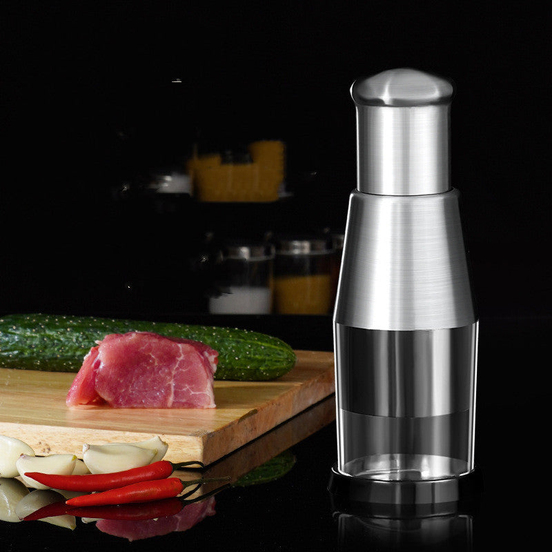 Silver oil bottle on a reflective surface with a dark background